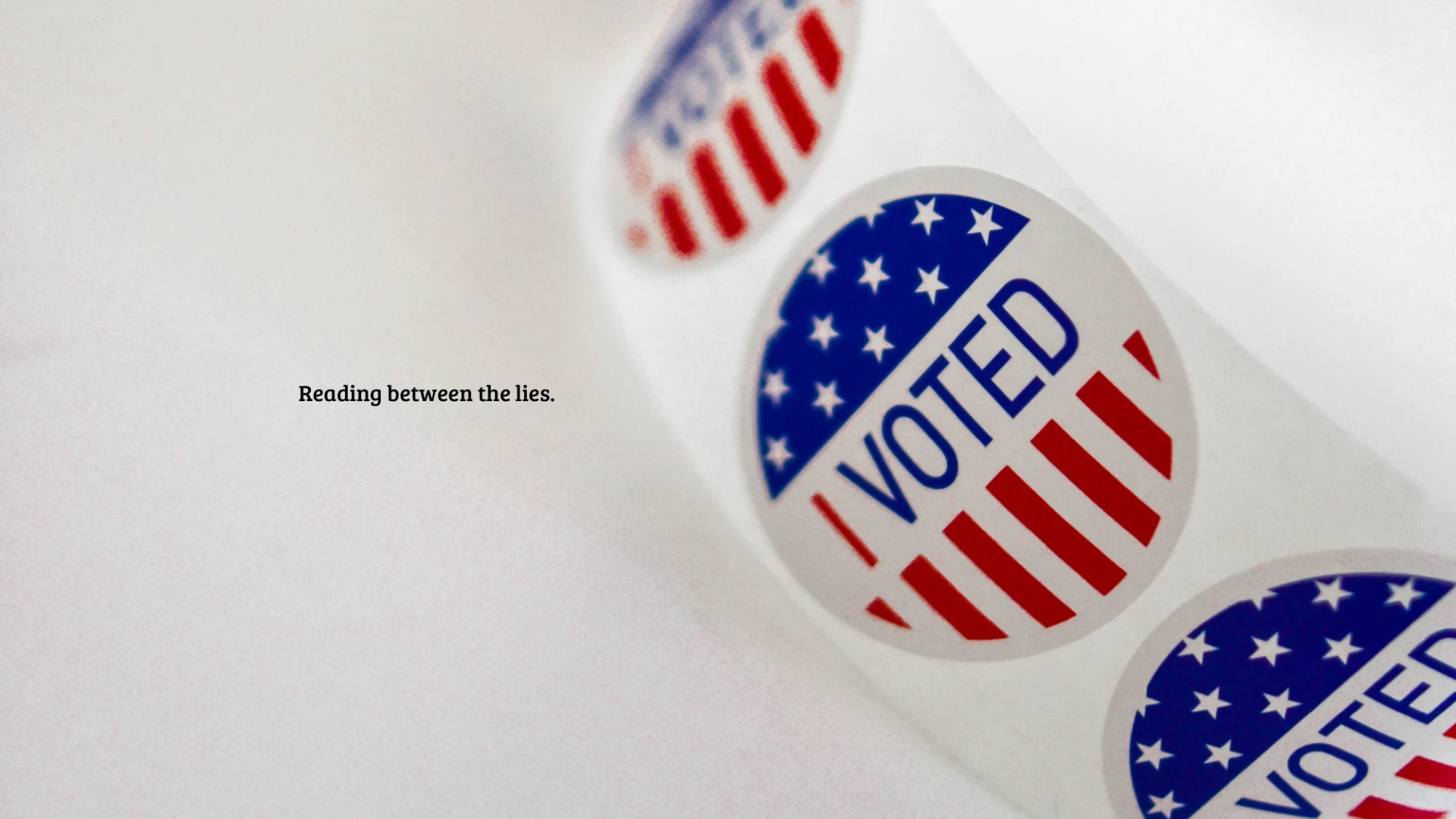Close-up of an object bearing the word VOTE. Text: “Reading between the lies.”