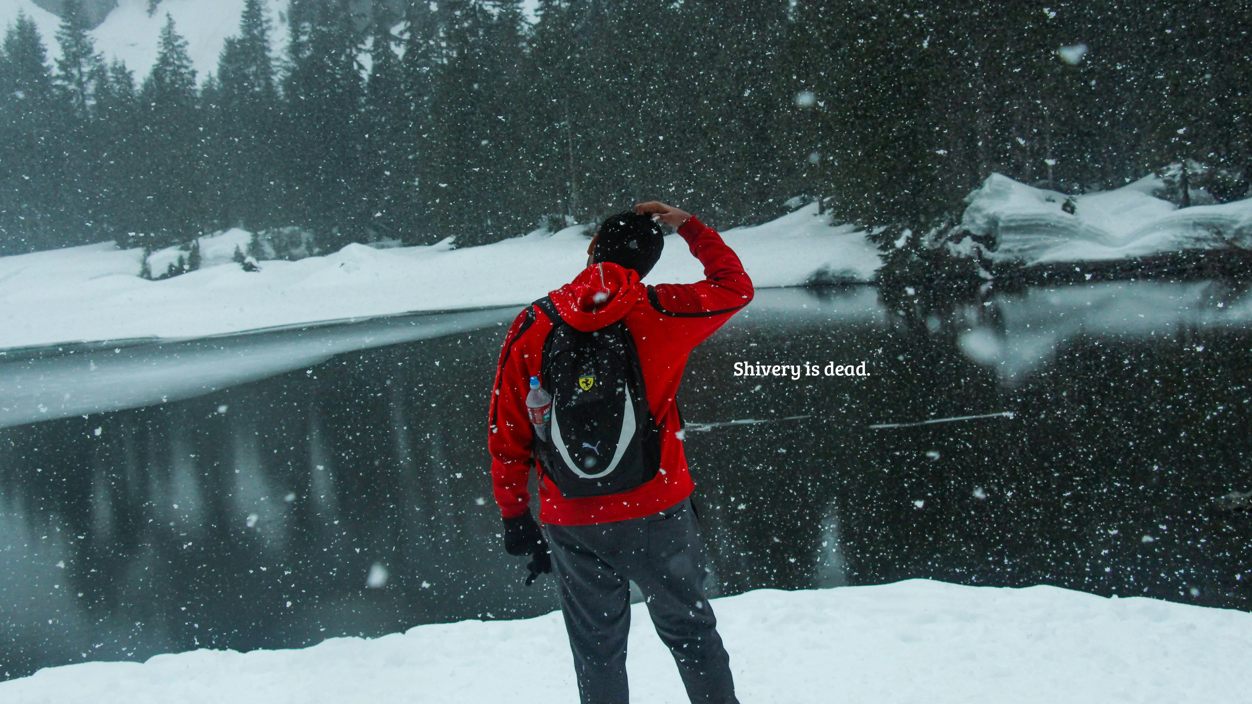 A person in a red jacket standing outdoors in snowy conditions. Text: “Shivery is dead.”